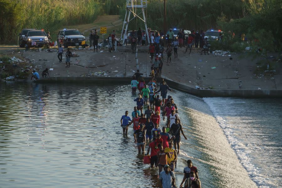 Haitian migrants cross the Rio Grande to get food and supplies near the Del Rio-Acuña Port of Entry in Ciudad Acuña, Coahuila state, Mexico on September 18, 2021. (Photo by PAUL RATJE/AFP via Getty Images)