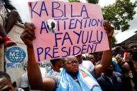 Supporters of the runner-up in Democratic Republic of Congo's presidential election, Martin Fayulu hold a sign before a political rally in Kinshasa, Democratic Republic of Congo, January 11, 2019. REUTERS/Baz Ratner