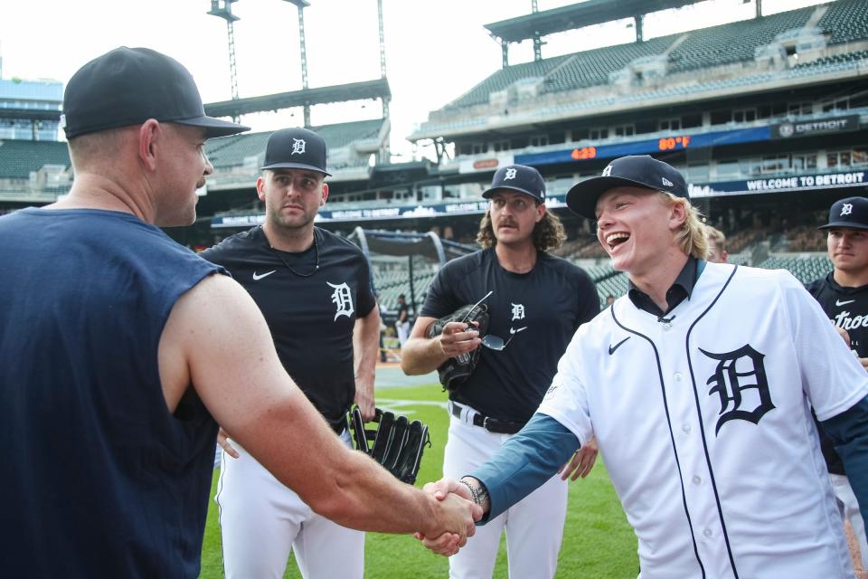 Tigers first-round draft pick Max Clark shakes hands with pitcher Tyler Alexander during warm up before a game between Tigers and Padres at Comerica Park on Friday, July 21, 2023.