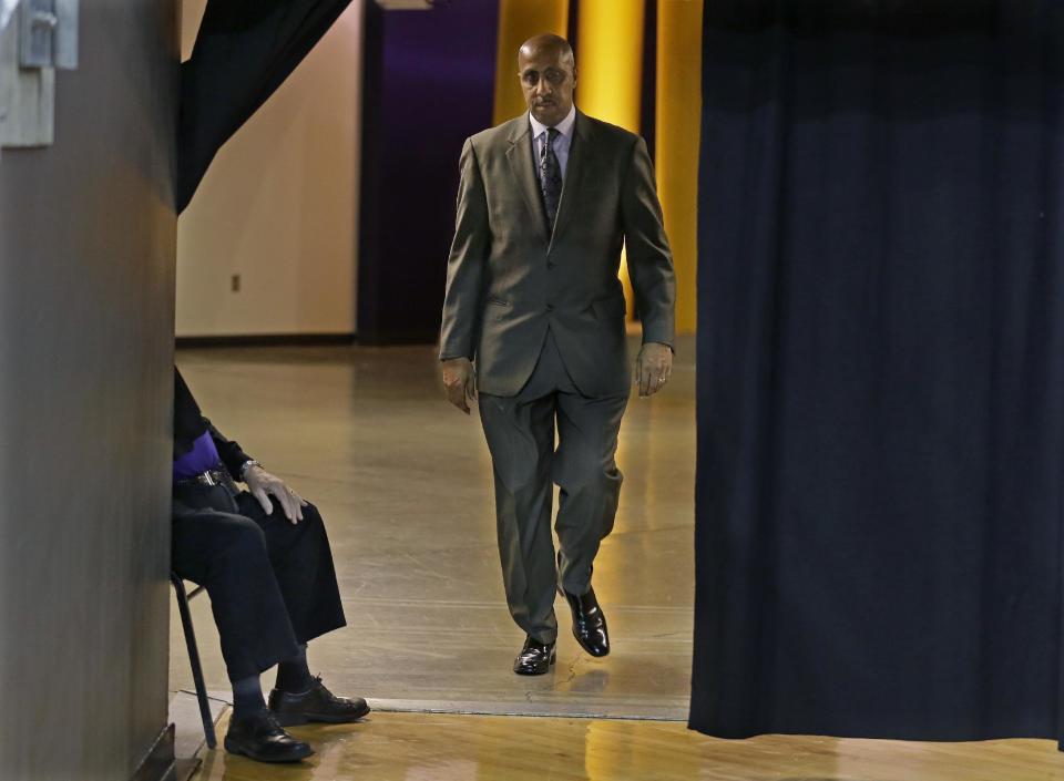 FILE - In this Jan. 18, 2017 file photo, Washington coach Lorenzo Romar walks past a curtain as he heads to the court for the team's NCAA college basketball game against Colorado in Seattle. Washington announced Wednesday, March 15, 2017, that Romar had been fired after 15 seasons at the school. (AP Photo/Ted S. Warren, file)