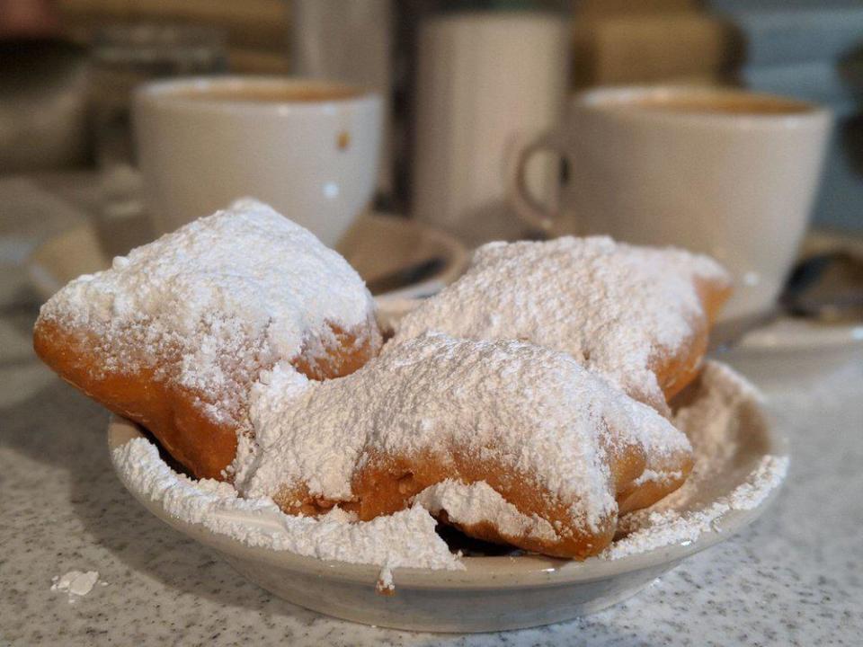 <p>No visitor to New Orleans should leave without sampling the city’s signature doughnut, <a href="https://www.thedailymeal.com/recipes/universals-mardi-gras-beignets-recipe?referrer=yahoo&category=beauty_food&include_utm=1&utm_medium=referral&utm_source=yahoo&utm_campaign=feed" rel="nofollow noopener" target="_blank" data-ylk="slk:the beignet;elm:context_link;itc:0;sec:content-canvas" class="link ">the beignet</a>. These pillowy indulgences are made by slicing dough into squares, deep-frying them and topping them with a mound of powdered sugar. They’re best enjoyed piping hot with a cup of chicory coffee at Cafe du Monde, which has been serving them since 1862 and is among the <a href="https://www.thedailymeal.com/eat/best-tourist-restaurants-america-list?referrer=yahoo&category=beauty_food&include_utm=1&utm_medium=referral&utm_source=yahoo&utm_campaign=feed" rel="nofollow noopener" target="_blank" data-ylk="slk:tourist trap restaurants that are actually really good;elm:context_link;itc:0;sec:content-canvas" class="link ">tourist trap restaurants that are actually really good</a>.</p>