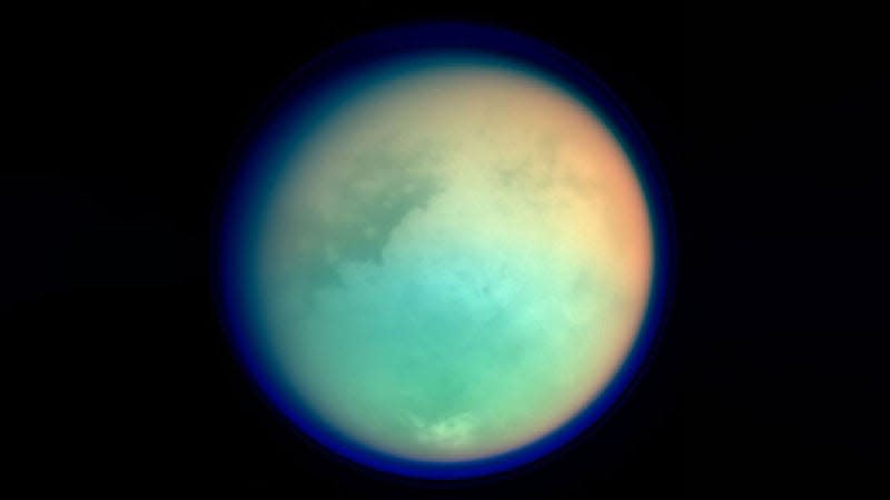 A pale blue image of Saturn's largest moon, Titan. 