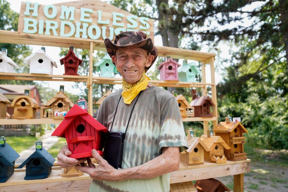 Tom Esshaki poses in front of birdhouses he built, which are now for sale in his driveway in Southfield on Tuesday, July 11, 2023. 
