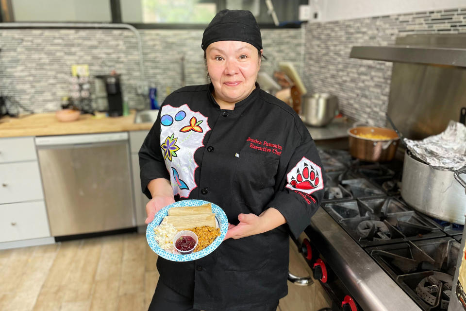 Jessica Pamonicutt, executive chef of a Native American catering company in Chicago, displays the contemporary indigenous meal she cooked for Elders at the American Indian Center of Chicago, on Aug. 3, 2022. (Claire Savage/Report for America via AP)