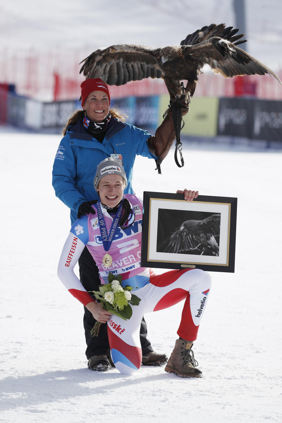 Switzerland's Marco Odermatt, bottom, poses for a photo with an eagle after he won the Men's World Cup super-G skiing race Friday, Dec. 6, 2019, in Beaver Creek, Colo. (AP Photo/John Locher)