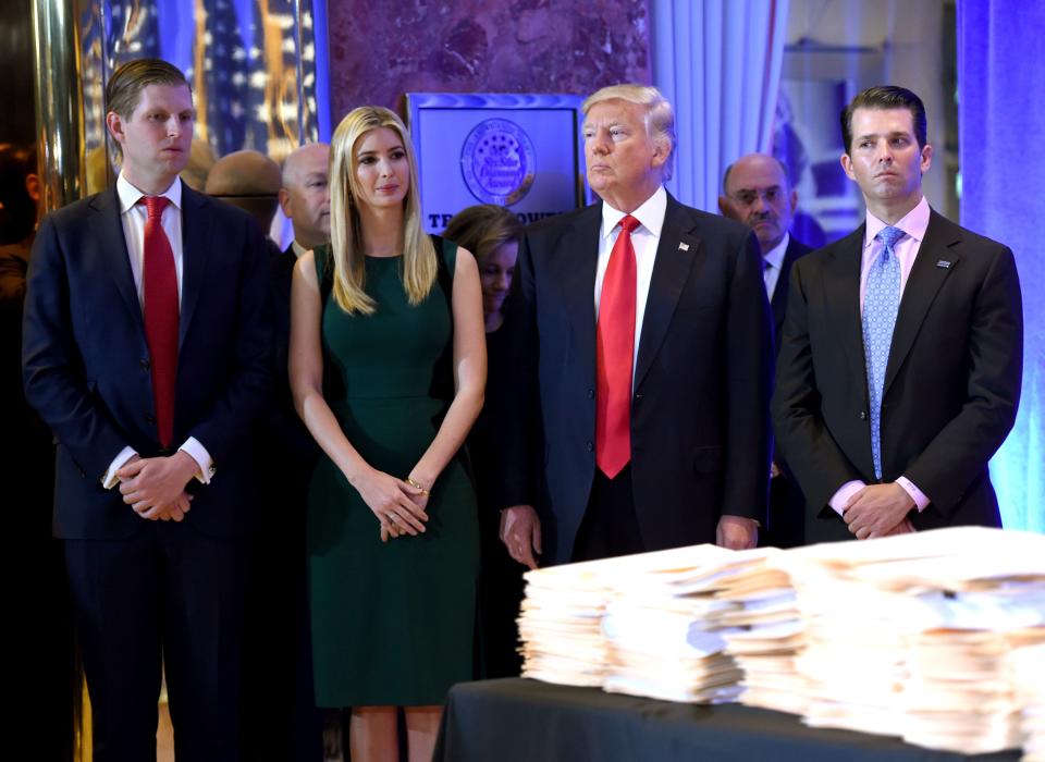 Donald Trump along with his children Eric(L) Ivanka and Donald Jr. arrive for a press conference January 11, 2017 at Trump Tower in New York.