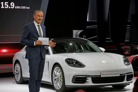 Porsche CEO Oliver Blume speaks near a Porsche Panamera 4 E-Hybrid. REUTERS/Jacky Naegelen