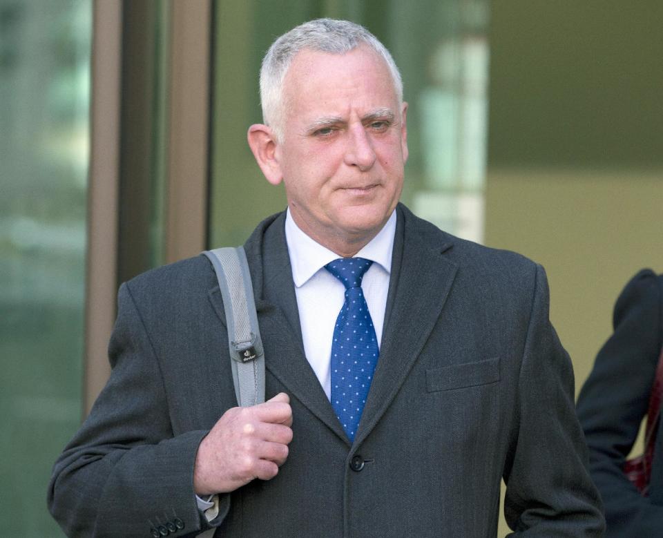 Former Barclays Bank employee Peter Charles Johnson leaves Westminster Magistrates court after appearing on charges of conspiracy to defraud in relation to the manipulation of the dollar Libor rate in London, Wednesday, Feb. 26, 2014. (AP Photo/Alastair Grant)