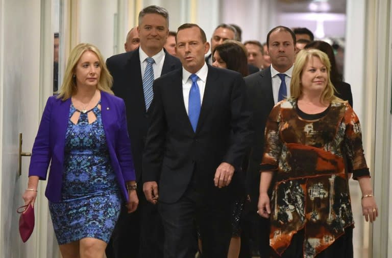 Australia Prime Minister Tony Abbott (C) walks though Parliament House in Canberra before he was dramatically ousted in a snap party vote forced by challenger Malcolm Turnbull on September 14, 2015