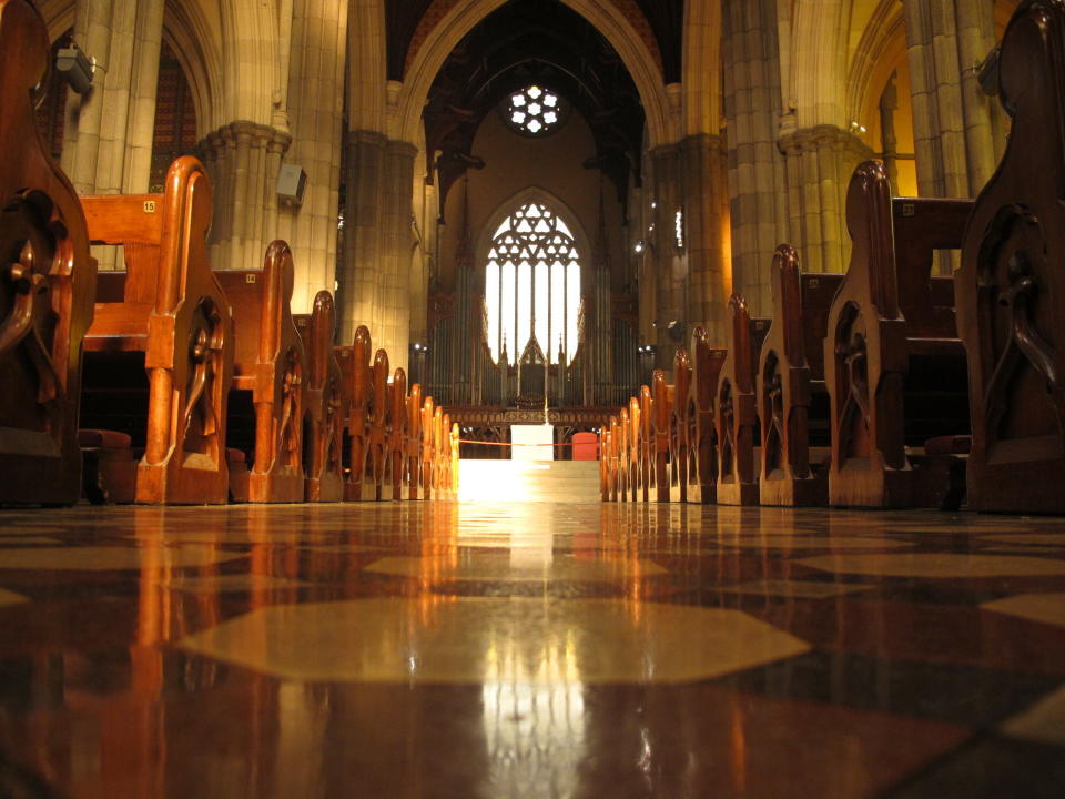FILE - In this Sept. 9, 2018, file photo, pews line the shiny isle inside the St. Patrick's Cathedral in Melbourne. Cardinal George Pell’s appeal against his convictions for child molestation was largely a question of who the jury should have believed, his accuser or a senior priest whose church role was likened to Pell’s bodyguard. Pell’s accuser was a 13-year-old choirboy when he alleged that he was abused by then-Melbourne Archbishop Pell at the city’s St. Patrick’s Cathedral in December 1996 and February 1997. (AP Photo/Rod McGuirk, File)