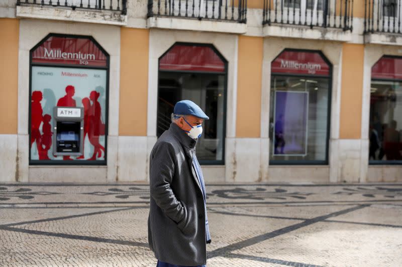 FILE PHOTO: A man wearing a mask is seen in downtown Lisbon