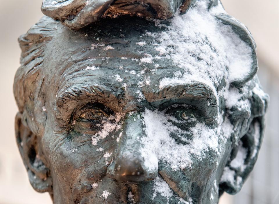 A smattering of wind-blown snow covers one side of Abraham Lincoln’s face on the statue outside the Peoria County Courthouse on Thursday, Feb. 4, 2021 in Downtown Peoria. Sleet, snow and high winds moved into the Peoria area Thursday with more snow and below-freezing temperatures expected over the weekend.