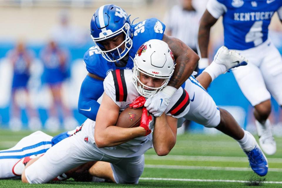 Ball State Cardinals tight end Tanner Koziol (88) is tackled by Kentucky Wildcats linebacker Trevin Wallace (32) during their 2023 game.