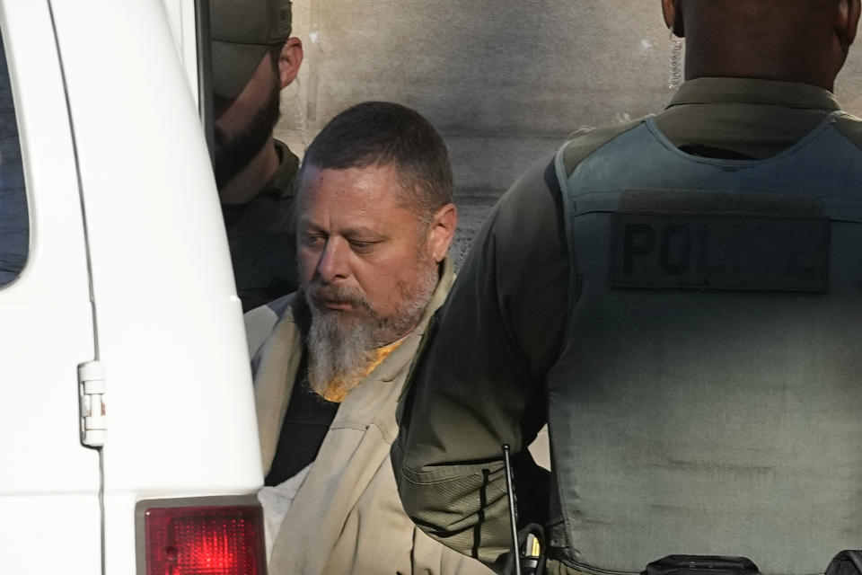 Officers escort Richard Matthew Allen, out of the Carroll County courthouse following a hearing, Tuesday, Nov. 22, 2022, in Delphi, Ind. Allen was charged last month with two counts of murder in the killings of Liberty German, 14, and Abigail Williams, 13. (AP Photo/Darron Cummings)