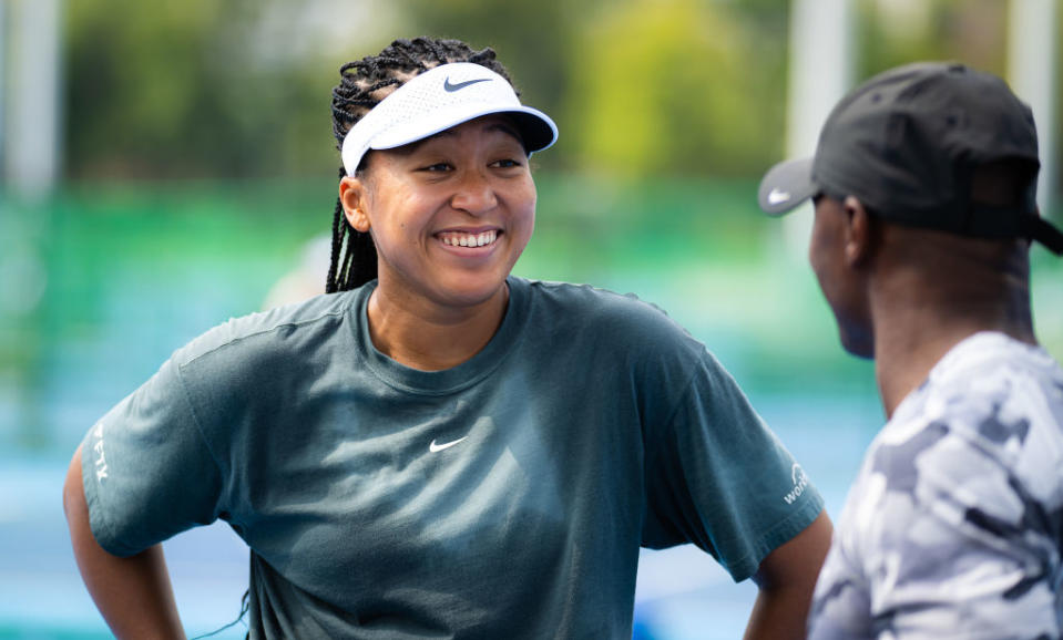 Close-up of Naomi smiling and wearing a T-shirt and cap