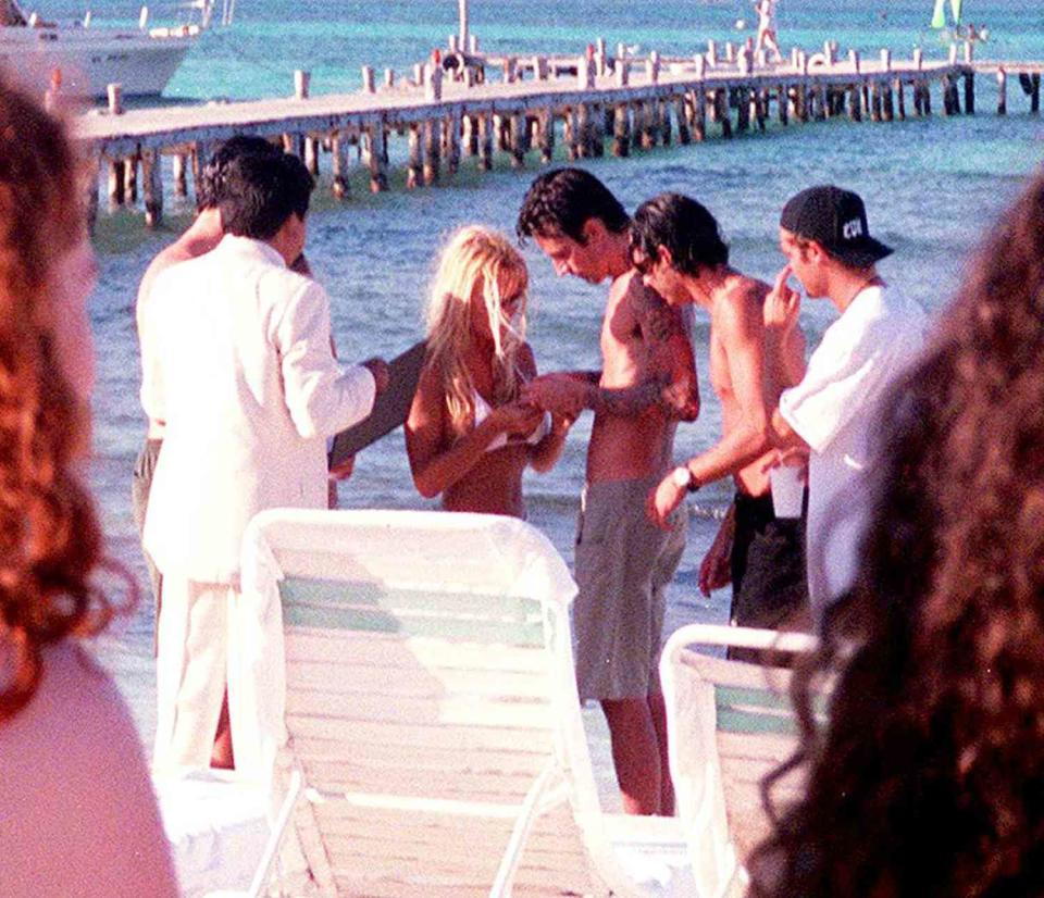 Pamela Anderson and Tommy Lee get married February 19, 1995 on the beach in Cancun, Mexico as fans watch nearby