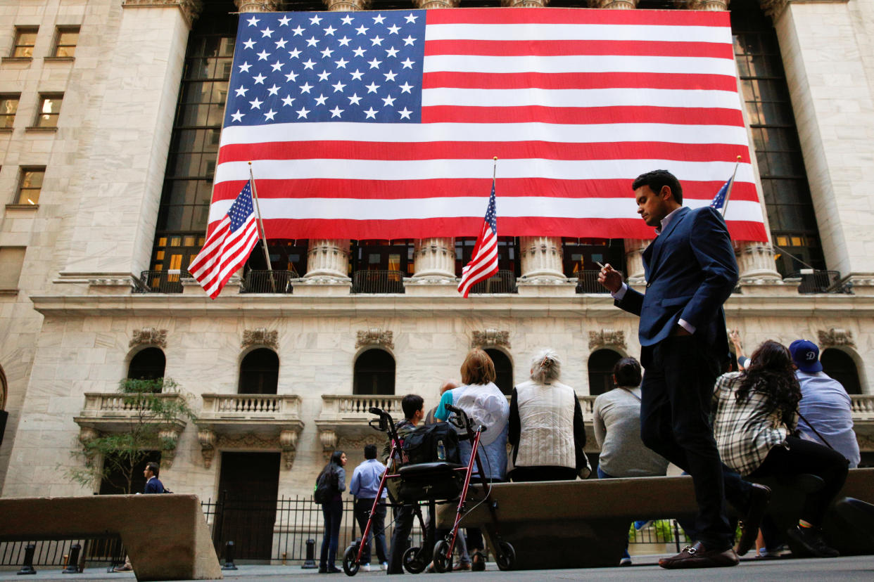 People sit outside the New York Stock Exchange (NYSE) in New York City, U.S., September 15, 2016.  REUTERS/Brendan McDermid