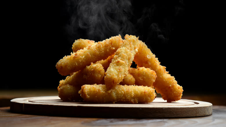 steamy mozzarella sticks on a plate