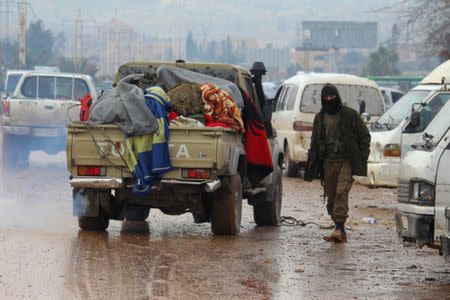 A rebel fighter stands near vehicles at insurgent-held al-Rashideen in the province of Aleppo, Syria December 22, 2016. REUTERS/Ammar Abdullah