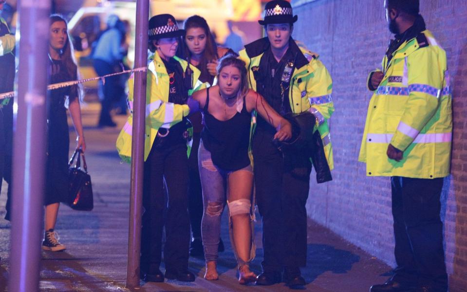 An injured woman is helped by police after the blast - Credit: Joel Goodman/LNP