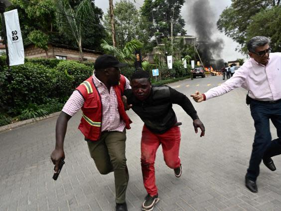 An injured man is taken from the scene (AFP/Getty)