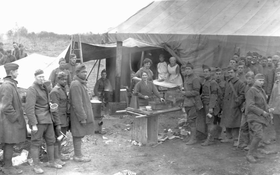 The Salvation Army volunteers give out fresh donuts to soldiers from front line huts in France in October, 1918.