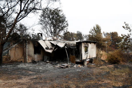 A house and its surroundings damaged by wildfires are seen at kibbutz Harel during a record heatwave, in Israel May 24, 2019. REUTERS/Ronen Zvulun