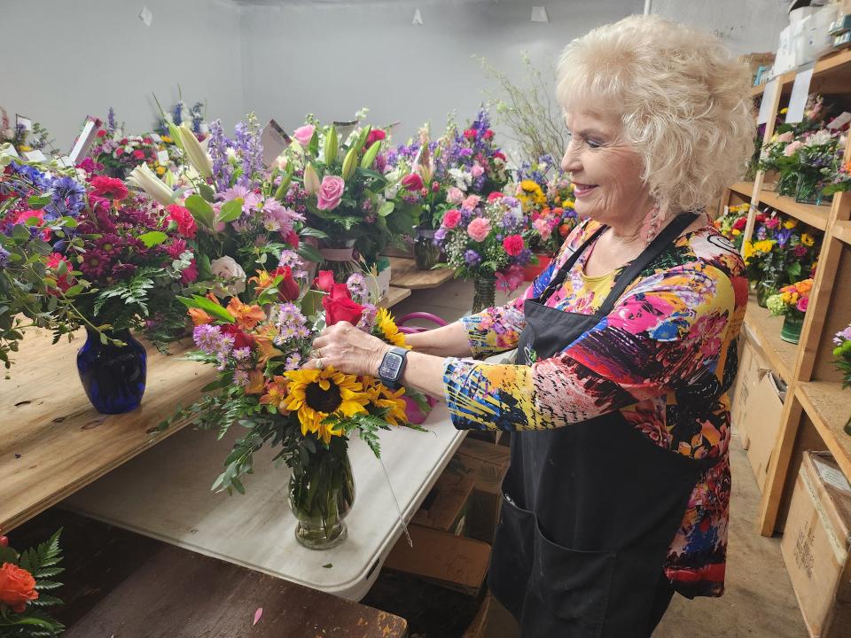 Mary Ruth Albracht, owner of Scotts Flowers, helps make arrangements to be delivered for Mothers Day, the biggest week of the year for local floral shops.