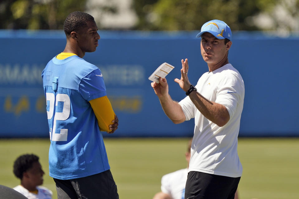 Los Angeles Chargers head coach Brandon Staley, right, talks to safety JT Woods during an NFL football rookie minicamp Friday, May 13, 2022, in Costa Mesa, Calif. (AP Photo/Marcio Jose Sanchez)
