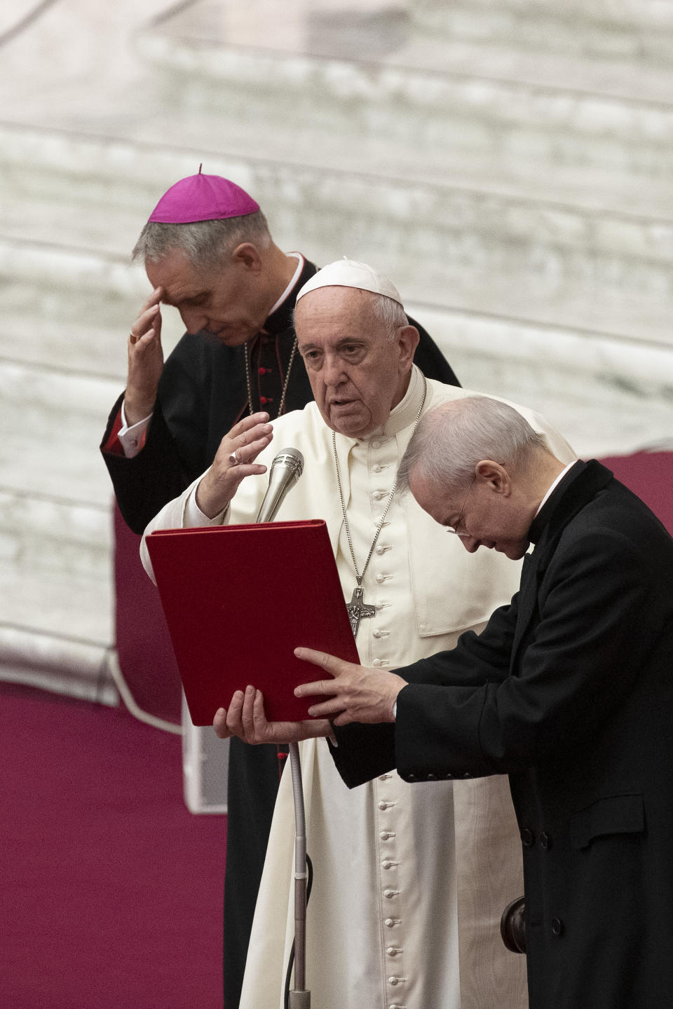 Pope Francis, flanked by Archbishop Georg Gaenswein, delivers his blessing in the Paul VI Hall at the Vatican during an audience with members of parish evangelization services, Monday, Nov. 18, 2019. (AP Photo/Alessandra Tarantino)