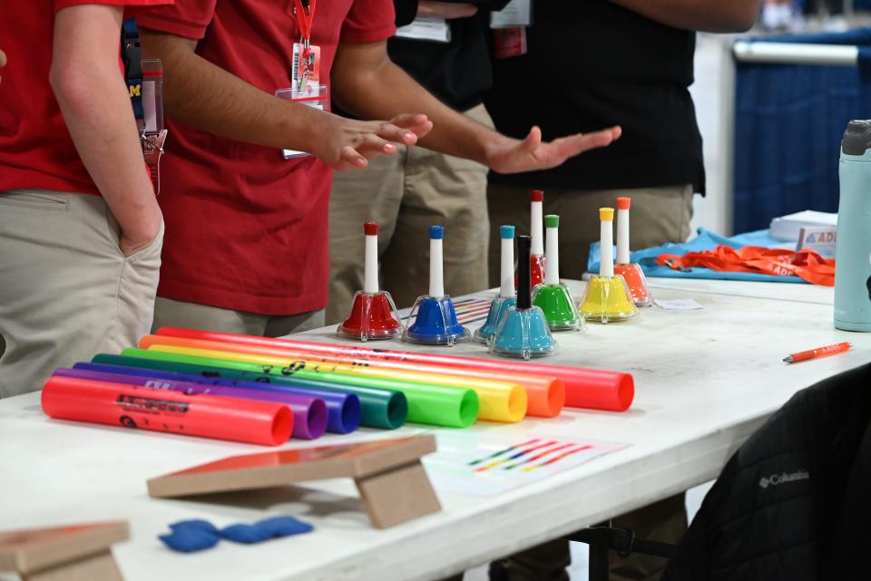 Students tap bells, learning Music Therapy at ADEC's table, at the GEAR UP I.G.N.I.T.E. Career Expo at St. Joseph County 4-H Fairgrounds on May 2, 2024.