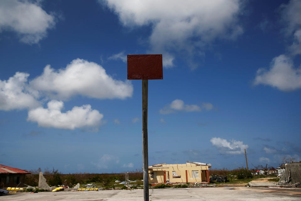 An empty basketball hoop and backboard is seen among homes in ruin at Codrington on the island of Barbuda just after a month after Hurricane Irma struck the Caribbean islands of Antigua and Barbuda