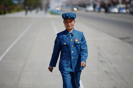 A man wears a pin with pictures of former North Korean leaders Kim Il-sung and Kim Jong-il in central Pyongyang, North Korea April 12, 2017. REUTERS/Damir Sagolj TPX IMAGES OF THE DAY