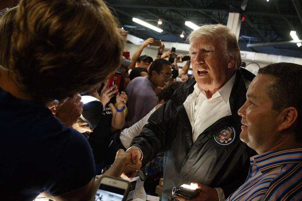 President Donald Trump shakes hands and hands out supplies after Hurricane Maria in 2017 in Guaynabo, Puerto Rico. 