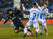 Real Madrid's Marcelo, left, duels for the ball with Leganes' Unai Bustinza during a Spanish Copa del Rey soccer match between Leganes and Real Madrid at the Butarque stadium in Leganes, Spain, Wednesday, Jan. 16, 2019. (AP Photo/Valentina Angela)