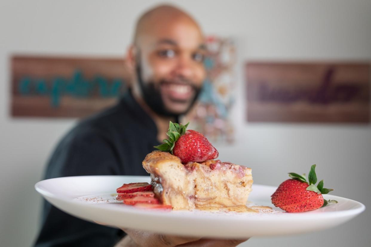 Man holding plate of food - Black-owned restaurants in LA