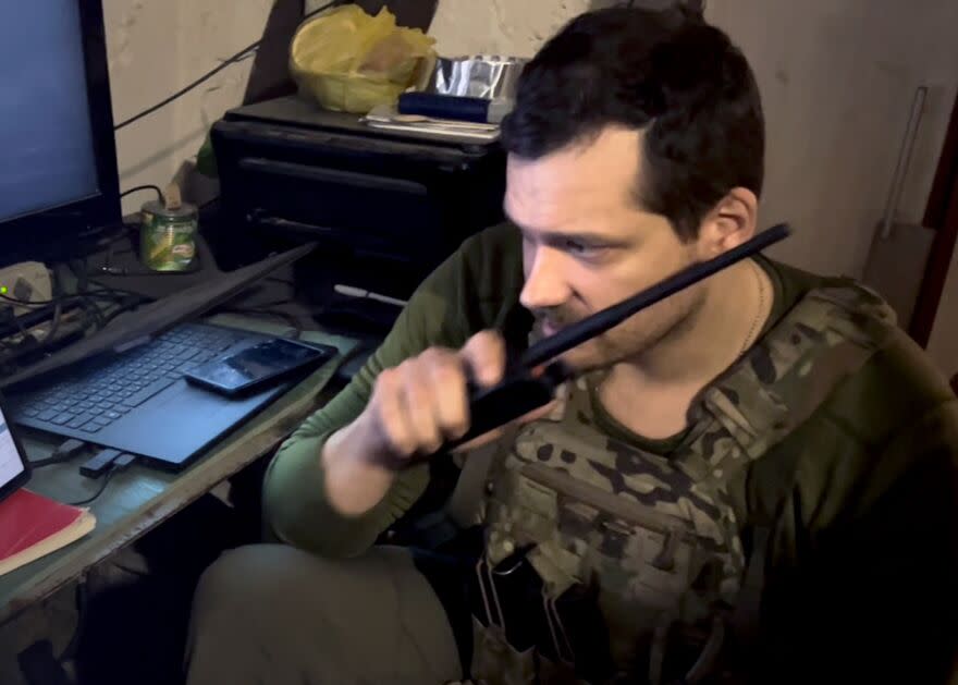 A Ukrainian battalion's mortar commander, who goes by the name Zeus, communicates coordinates and adjustments to his team.