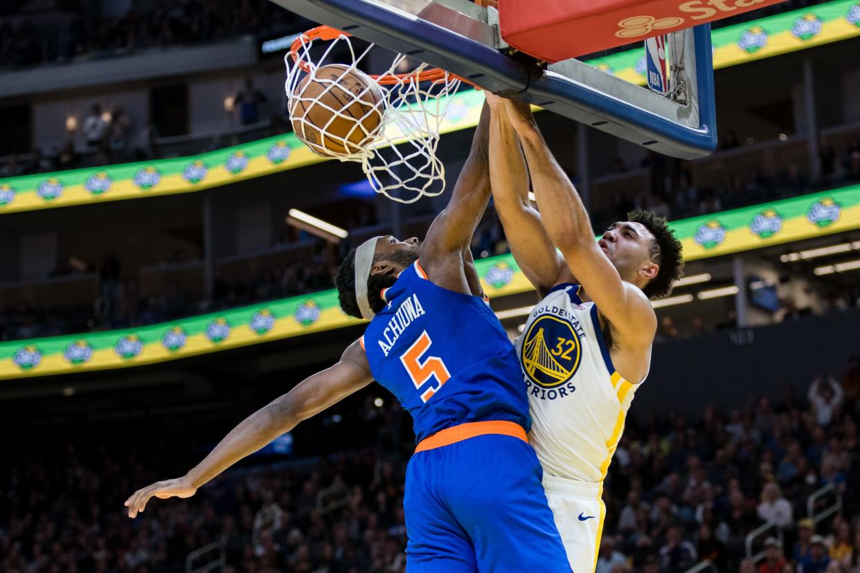 Mar 18, 2024; San Francisco, California, USA; Golden State Warriors center Trayce Jackson-Davis (32) dunks against New York Knicks forward Precious Achiuwa (5) during the second half at Chase Center. Mandatory Credit: John Hefti-USA TODAY Sports