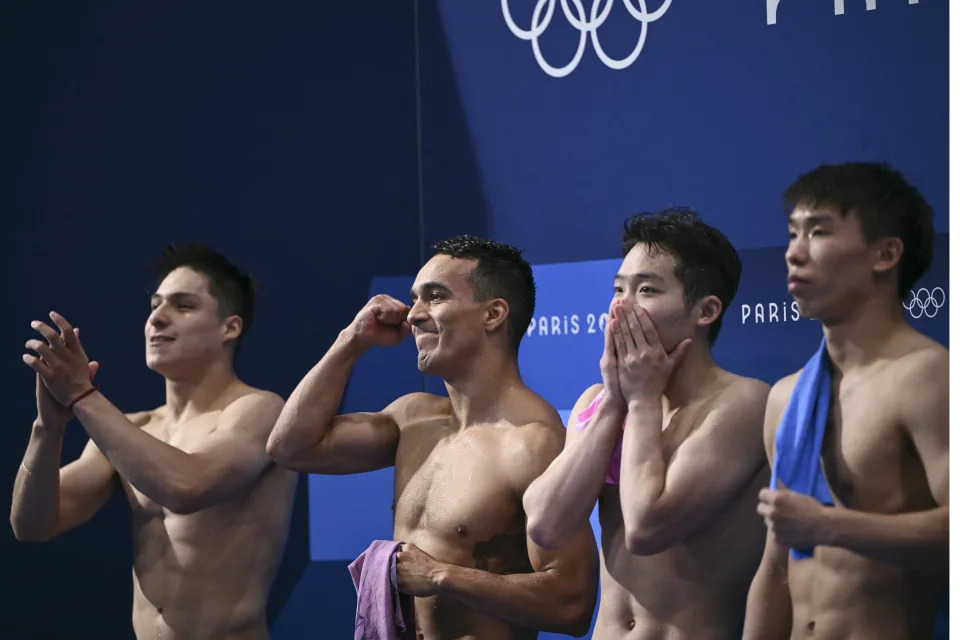 Silver medallists Mexico's Juan Manuel Celaya Hernandez and Osmar Olvera Ibarra (L) and gold medallists China's Long Daoyi and Wang Zongyuan celebrate following the men's synchronised 3m springboard diving final at the Paris 2024 Olympic Games at the Aquatics Centre in Saint-Denis, north of Paris, on August 2, 2024. (Photo by SEBASTIEN BOZON / AFP) (Photo by SEBASTIEN BOZON/AFP via Getty Images)