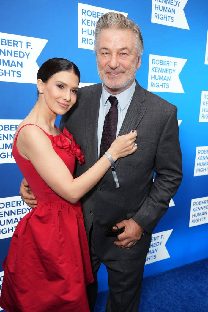 The couple smile for a photo at a red carpet event