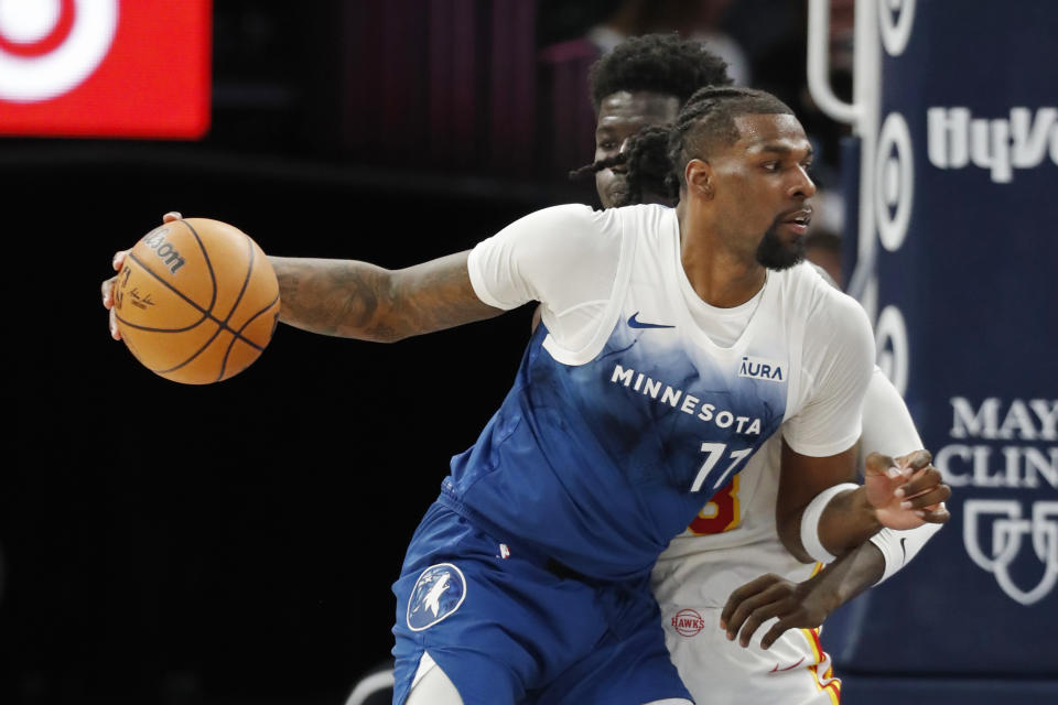 Minnesota Timberwolves center Naz Reid (11) works around Atlanta Hawks forward Mouhamed Gueye during the fourth quarter of an NBA basketball game Friday, April 12, 2024, in Minneapolis. (AP Photo/Bruce Kluckhohn)