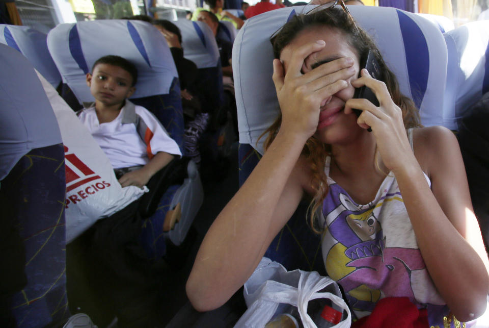 <p>A girl cries as she talks with her father who will remain in Ecuador as she return to Venezuelan in an airplane sent by Government of Venezuela. Quito, Ecuador, Wednesday, September 5, 2018. (AP Photo/Dolores Ochoa) </p>