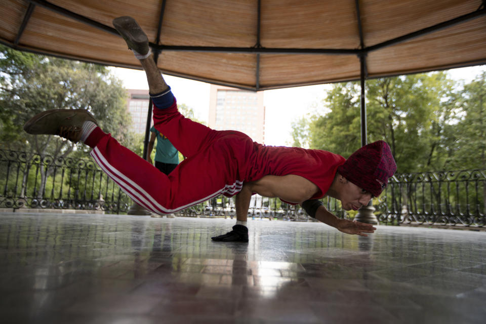 FILE - In this Tuesday, Aug. 18, 2020 file photo, Carlos Cruz, a breakdancer, practices at a kiosk in Alameda park after being closed off to the public for nearly five months due to the new coronavirus pandemic, in Mexico City. Breakdancing has been confirmed as an official Olympic sport. The International Olympic Committee’s pursuit of urban events to lure a younger audience saw street dance battles officially added to the medal events program at the 2024 Paris Games. (AP Photo/Fernando Llano, File)