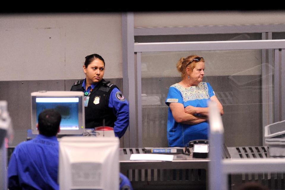 In this Monday, Aug. 1, 2011, photo, an unidentified traveler undergoes a secondary security screening at San Francisco International Airport in San Francisco. Airline executives said Tuesday, Oct. 16, 2012, at a global aviation conference that Airport security needs to undergo a radical overhaul or else passengers will become further disgruntled, lines will grow and terminals will be overwhelmed. "We simply can't cope with the expected volume of passengers with the way things are today," said Tony Tyler, director general and CEO of the International Air Transport Association, the airlines' trade group. (AP Photo/Noah Berger)