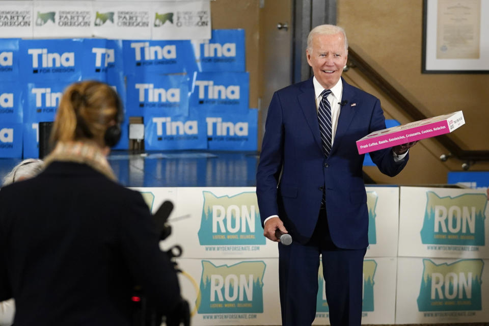 President Joe Biden holds a box of doughnuts during a grassroots volunteer event with the Oregon Democrats at the SEIU Local 49 in Portland, Ore. Friday, Oct. 14, 2022. (AP Photo/Carolyn Kaster)