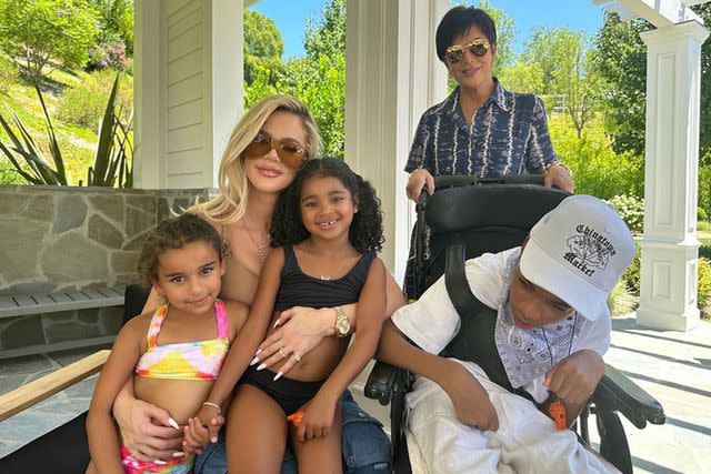 <p>Khloe Kardashian Instagram</p> Kris Jenner, Khloe Kardashian, True and Dream pose next to Amari in a wheelchair.