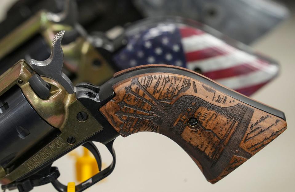 Guns, shooting accessories and other merchandise are displayed in the exhibit hall at the annual NRA Convention on Saturday, April 15, 2023, at the Indiana Convention Center in Indianapolis.