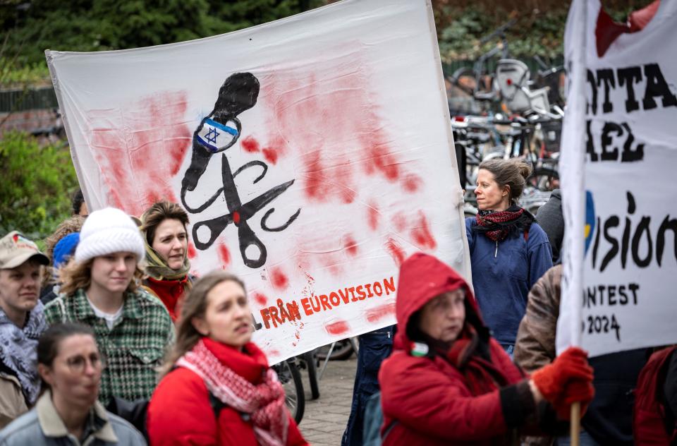 Participants hold up banners during a demonstration outside the City Hall in Malmö, Sweden on April 10, 2024 in connection with the municipal board's consideration of a citizens' proposal to stop Israel's participation in the Eurovision Song Contest. The demo was organised by the citizens' initiative 'No Eurovision in Malmö with Israel's participation'. (Photo by Johan NILSSON / TT News Agency / AFP) / Sweden OUT (Photo by JOHAN NILSSON/TT News Agency/AFP via Getty Images)