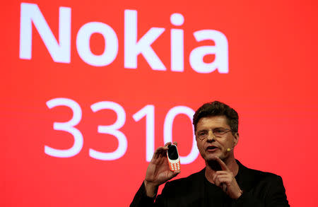 Arto Nummela, CEO of Nokia-HMD, holds up a Nokia 3310 device during a presentation ceremony at Mobile World Congress in Barcelona, Spain, February 26, 2017. REUTERS/Paul Hanna