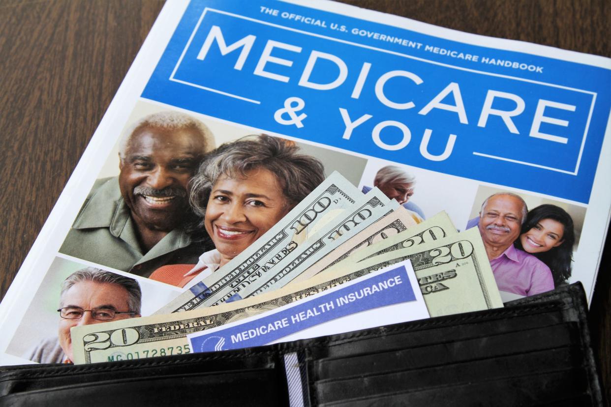 edicare and Social Security cards with USA currency cash.